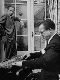 Oswald looks on as Peter Purlow assesses the zither damage.